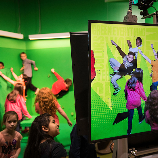 children playing with a green screen